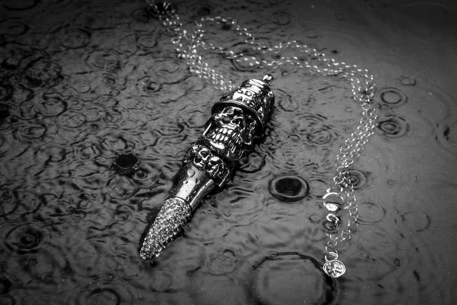 Pure Collection pendant on a rain-speckled surface