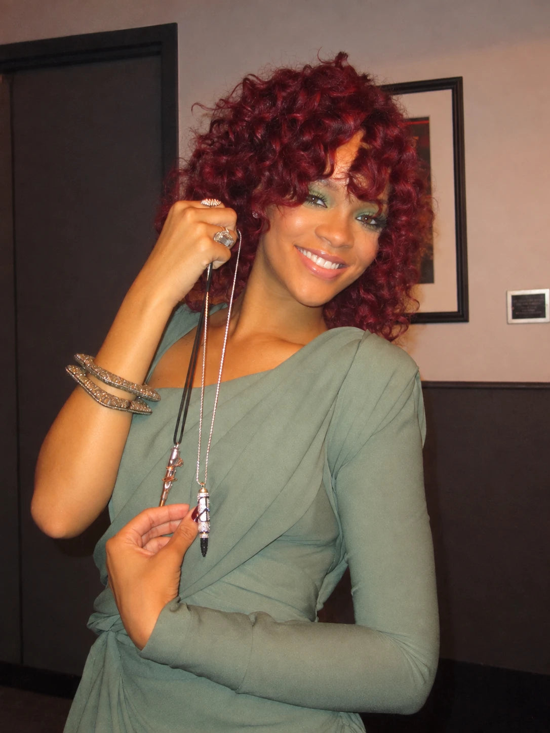 Rihanna holding a Bullets 4 Peace pendant; archive photo edited to remove surrounding people